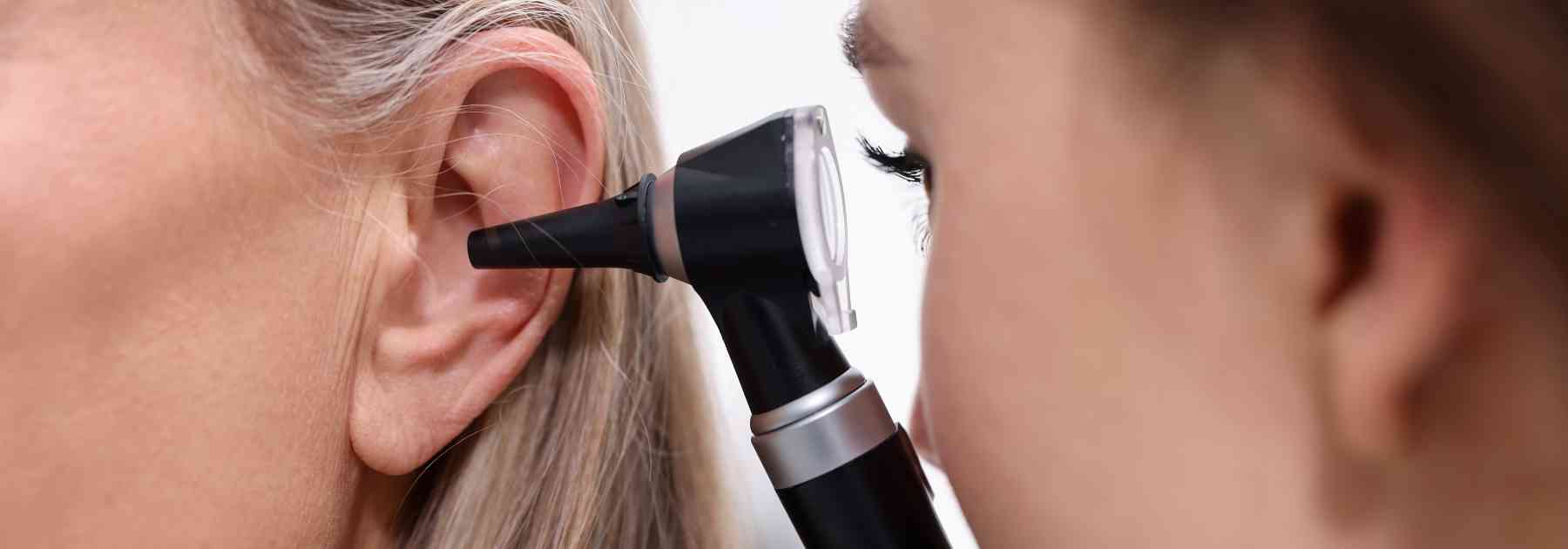 female doctor looking in patient's ear