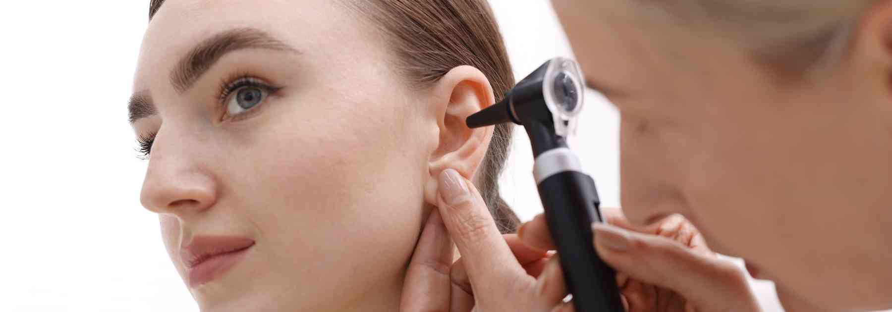 doctor looking in girl's ear