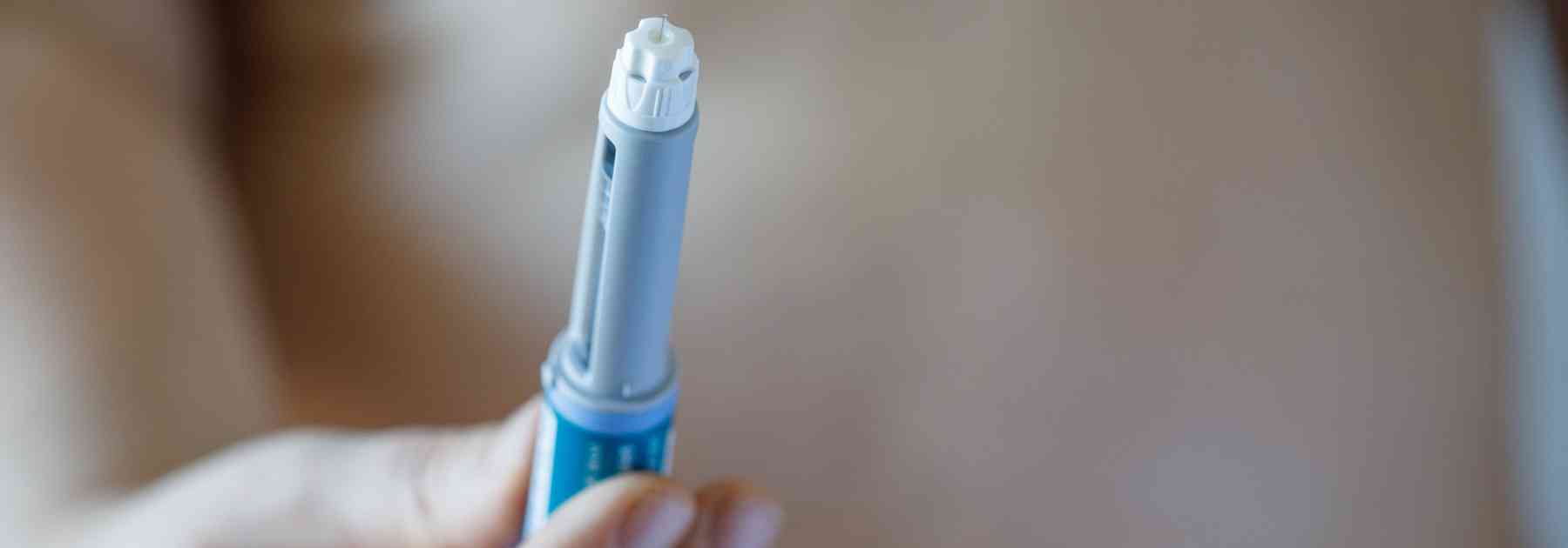 person holding weight loss injection