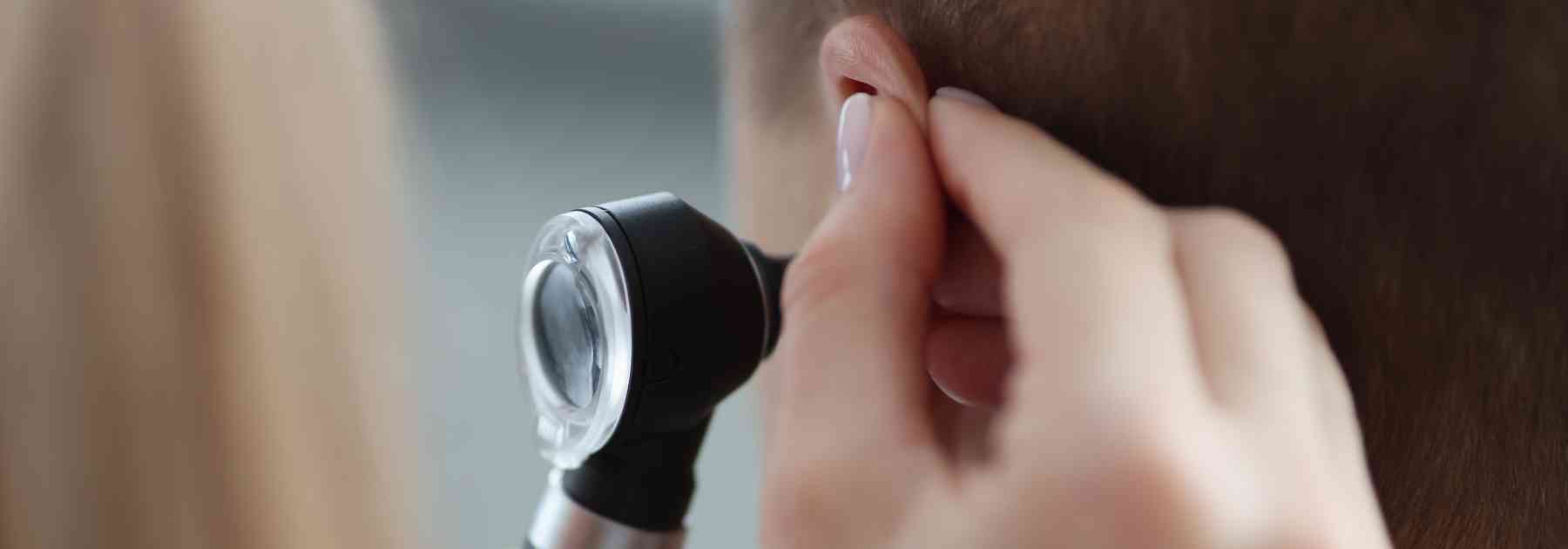 doctor looking in ear of patient