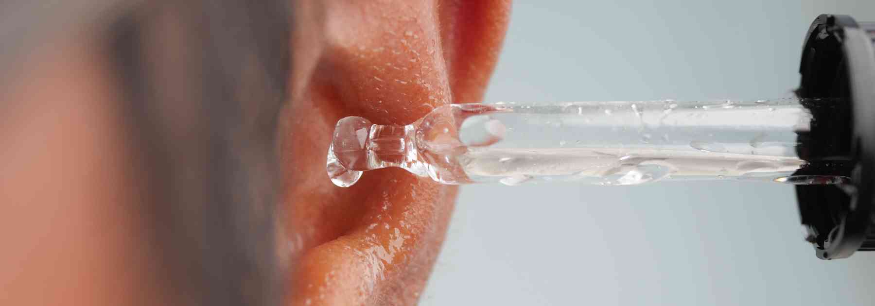 close-up of man using ear drops