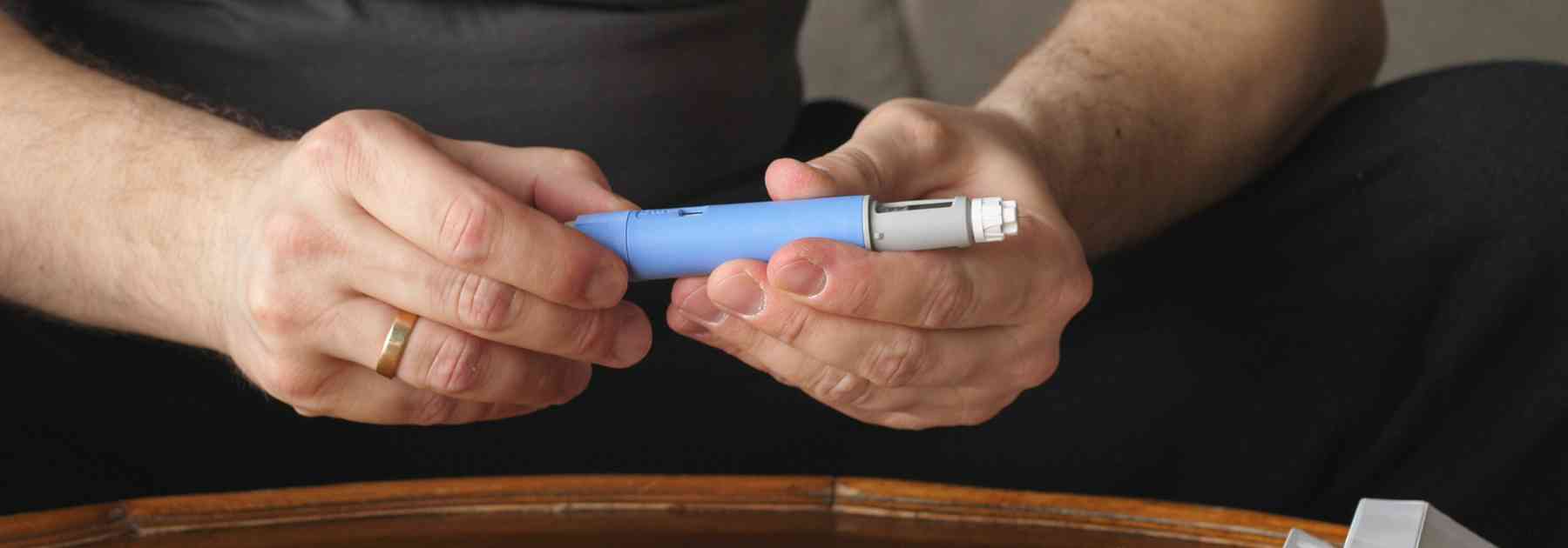 person holding weight loss injection