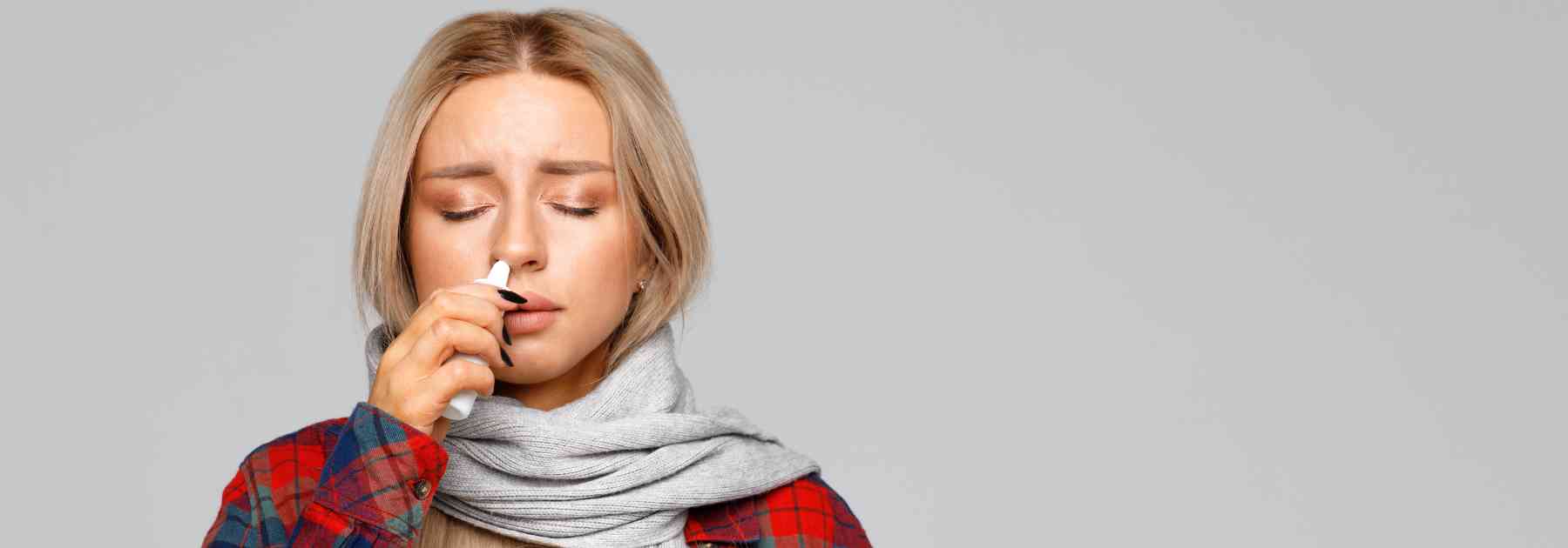 young woman using nasal spray