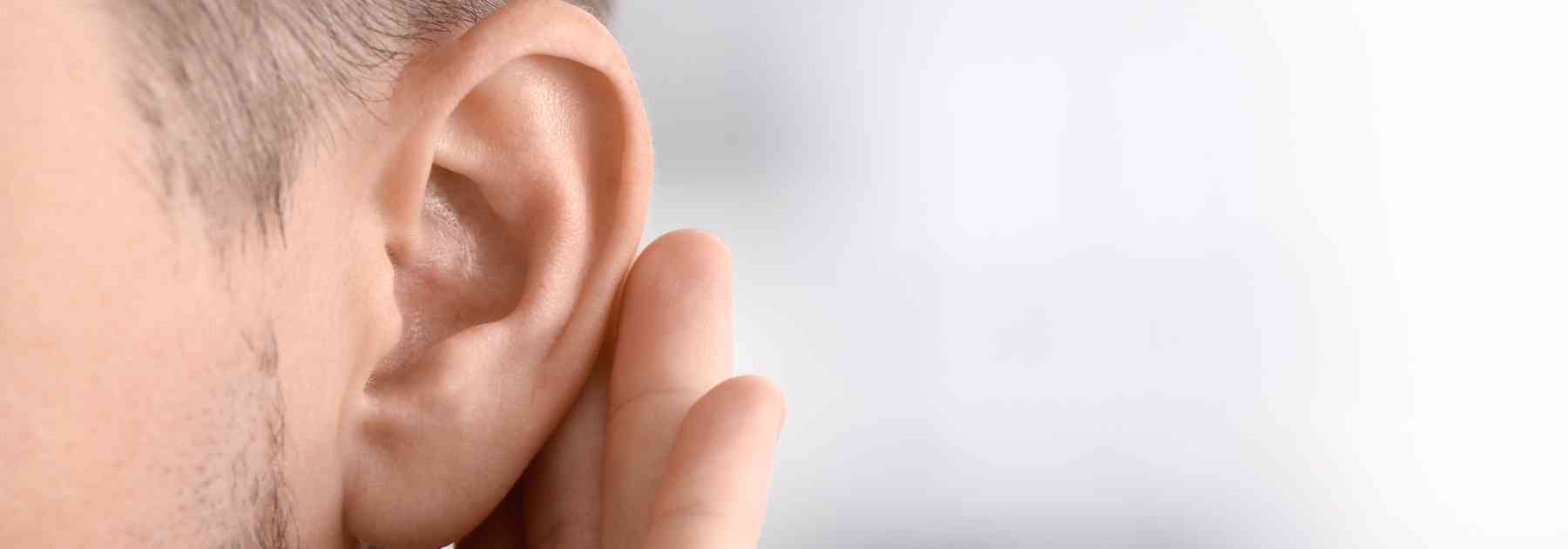 young man holding his ear