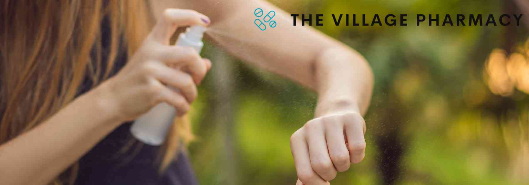 woman applying insect repellent to her arm