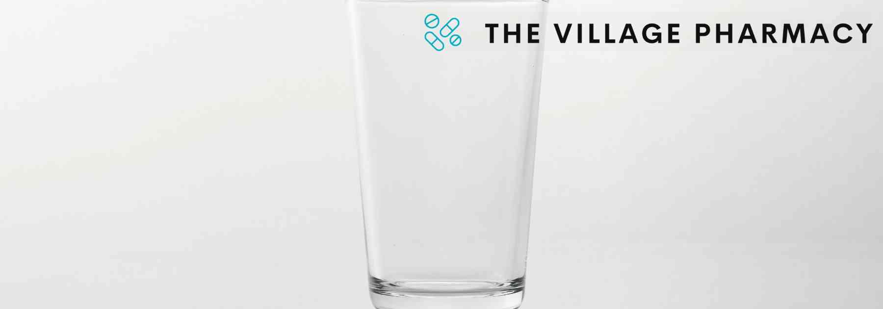 empty drinking glass on grey background