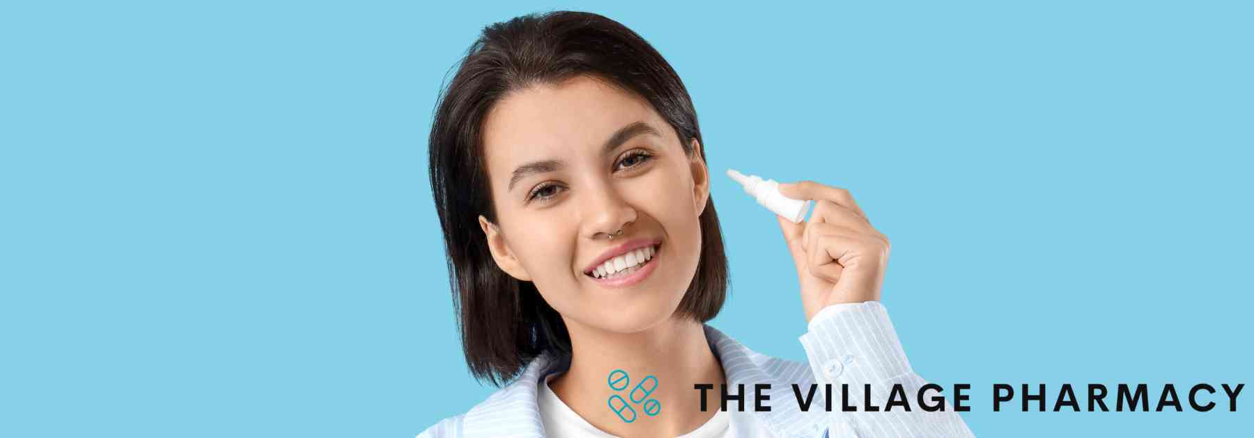 woman holding bottle of ear drops on blue background