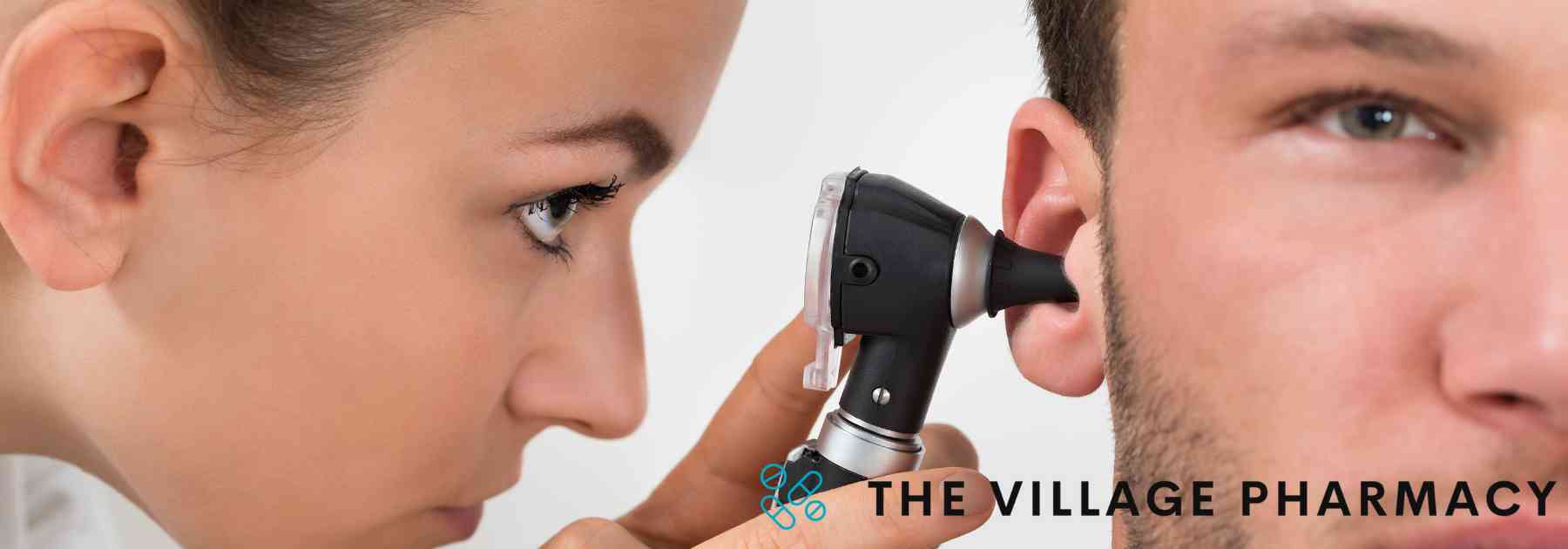 female doctor examining ear of male patient